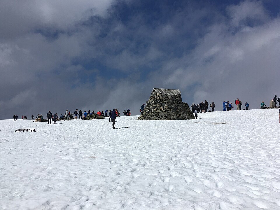 The snowy summit of Ben Nevis with its stone shelter
